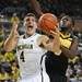 Michigan freshman Mitch McGary juggles the ball around Iowa sophomore Gabriel Olaseni in the second half at Crisler Center on Sunday, Jan. 6. Michigan beat Iowa 95-67 in the Big Ten home opener. Melanie Maxwell I AnnArbor.com